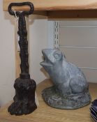 A late Georgian Coalbrookdale cast iron doorstop modelled as a lion's paw and a lead frog garden