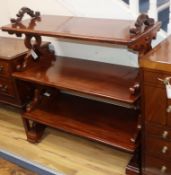 A Victorian mahogany three-tier rectangular buffet having carved pierced supports and trestle end