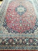 A Tabriz style red ground carpet 394 x 256cm