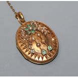 A Victorian yellow metal, emerald and seed pearl set oval locket, 35mm.