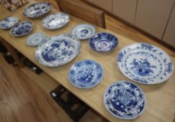 A collection of eleven 18th century Delft blue and white dishes largest diameter 35cm (mostly a.f.)