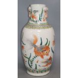 A Chinese famille verte vase, with twin elephant handles and decorated with shubunkins, restored