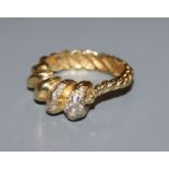 A modernist yellow metal and diamond set spiral form dress ring, size P.