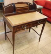 An Edwardian satinwood banded mahogany desk W.84cm