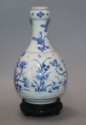 A Chinese Kangxi blue and white bottle vase, on hardwood stand vase excluding stand 23cm