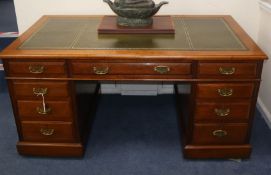 An Edwardian walnut pedestal desk W.152cm