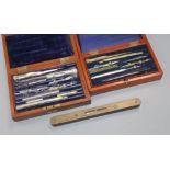 Two cased drawing sets and a level