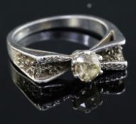 A platinum and single stone diamond ring, with diamond set shoulders and textured setting, size T.