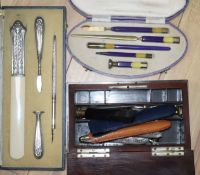 A Burr yew stationery box, two cased writing sets and sundries