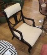 An Arts and Crafts ebonised nursing chair