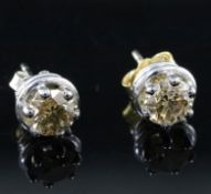 A pair of white metal and coloured diamond set ear studs, (the brilliant-cut stones each with a