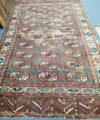 A Bokhara burgundy ground carpet 287 x 172cm