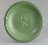 A Chinese celadon glazed 'twin fish' dish, Qing dynasty, the centre moulded with twin carp within an