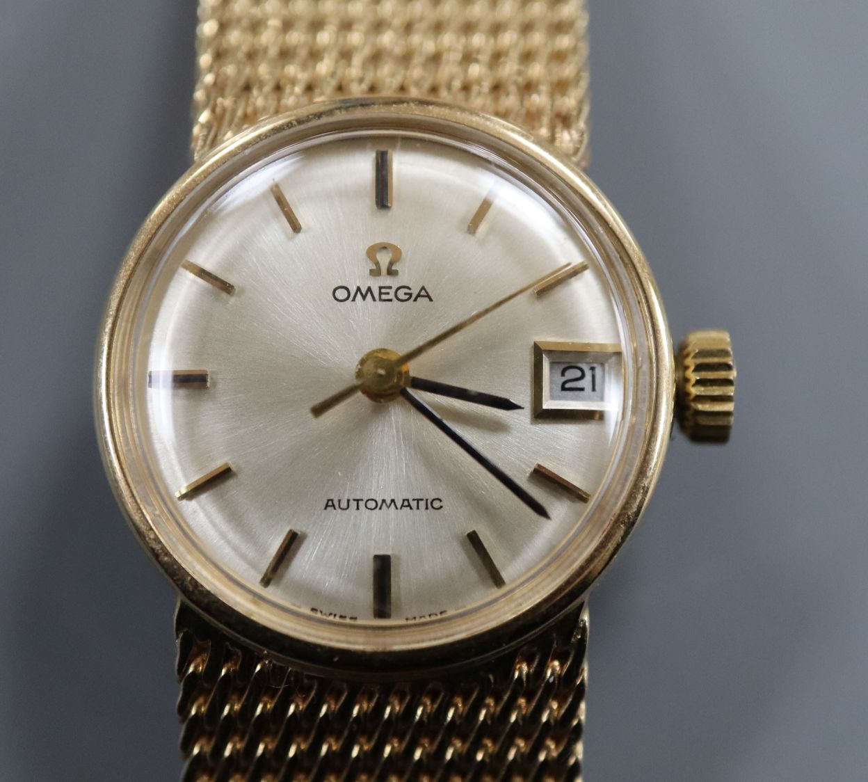 A lady's 1960's 9ct gold Omega automatic wrist watch, on integral 9ct gold Omega bracelet, gross