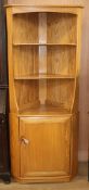 An Ercol Windsor light elm corner cabinet W.76cm