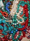 Fourteen assorted ethnic and other bead necklaces including coral, malachite and tiger's eye