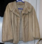 A blonde mink coat, three quarter sleeves, waist length, evening jacket