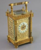 An early 20th century French ormolu hour repeating carriage clock, in ornate scrollwork case with