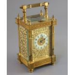 An early 20th century French ormolu hour repeating carriage clock, in ornate scrollwork case with