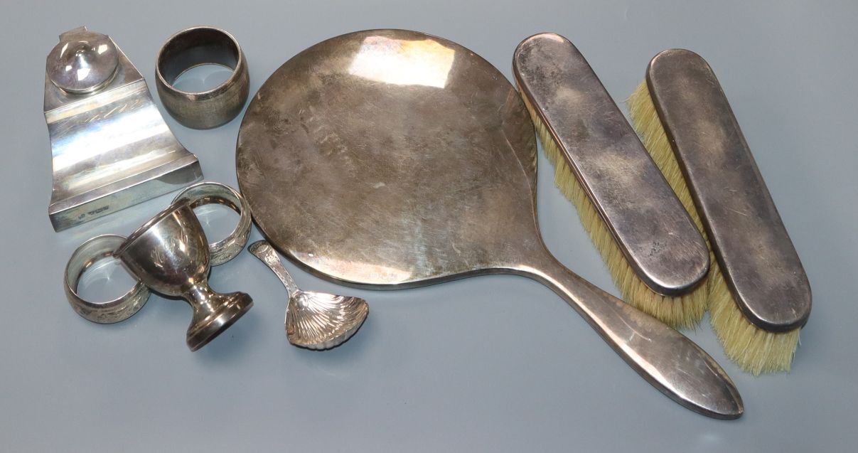 A George III silver caddy spoon, pair of silver clothes brushes and hand mirror, ink well, egg