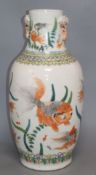 A Chinese famille verte vase, with twin elephant handles and decorated with shubunkins, restored