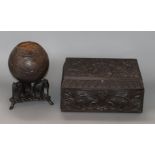 A Ceylonese carved ebony box and a coconut shell and 'elephant' stand