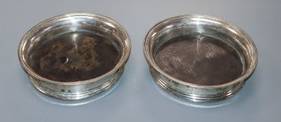 A pair of 19th century Dutch 833 white metal coaster, with wooden bases, 13.8cm.