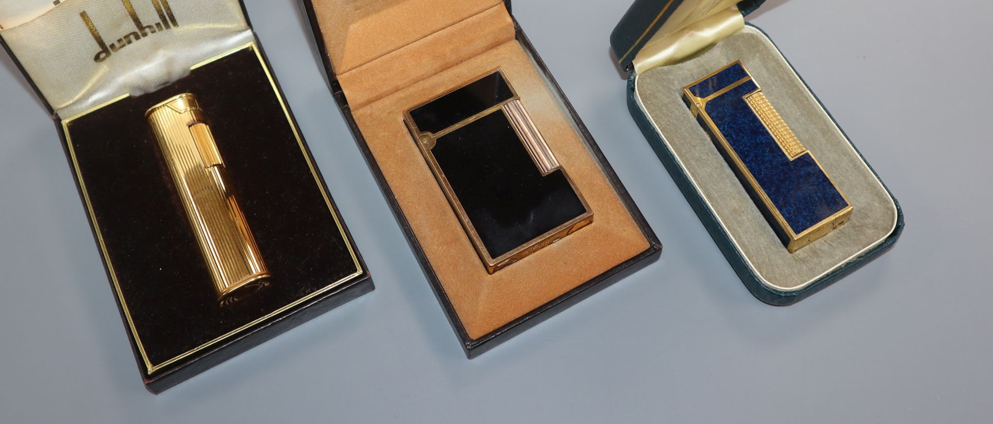 Two Dunhill lighters and a Dupont lighter, all cased