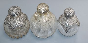 Three assorted late Victorian or Edwardian silver mounted cut glass globular scent bottles,