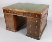 A Victorian mahogany partner's desk, with tooled green skiver and each side fitted with six