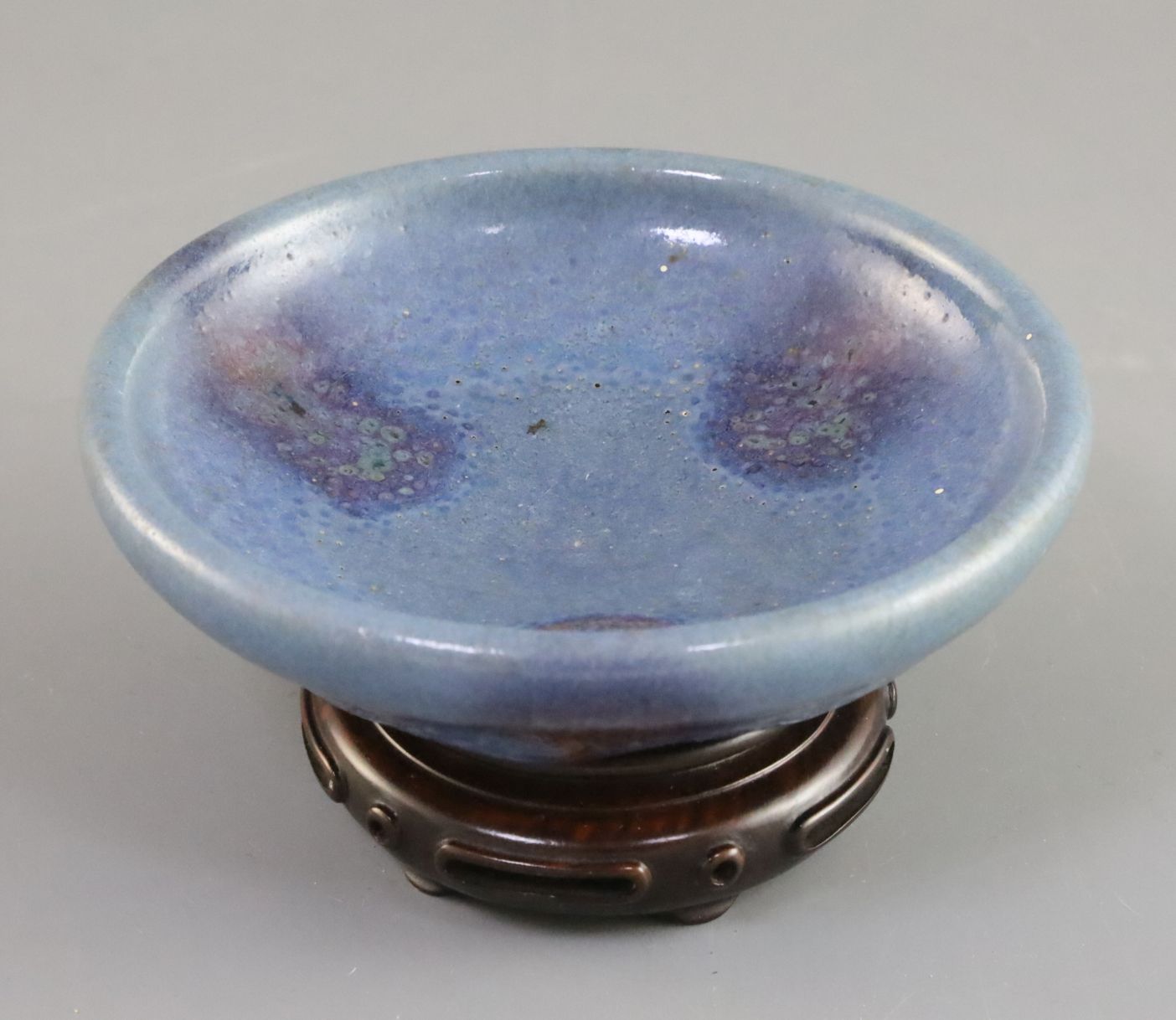 A Chinese Jun type purple-splashed dish, Qing dynasty, unglazed dark brown disc foot, D. 12.5cm,