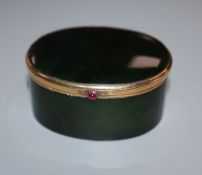 A Continental 18k yellow metal mounted, green nephrite jade oval pill box, with cabochon button,