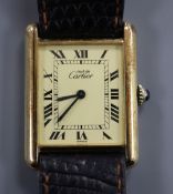 A lady's silver gilt Must de Cartier manual wind rectangular wrist watch, with Roman dial, on