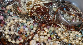 A box of assorted costume jewellery.