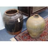 A large black glazed pottery jar and one other jar H.52cm