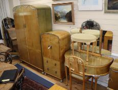 A 1930's blond walnut seven-piece bedroom suite decorated with silvered metal swags, comprising: