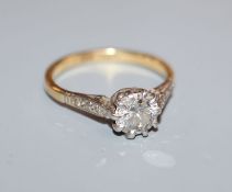 A diamond solitaire ring, in plat and 18ct with diamond-set shoulders, original ivorine box, size