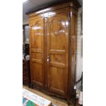 A 19th century French walnut armoire enclosed by a pair of shaped panelled doors H.252cm