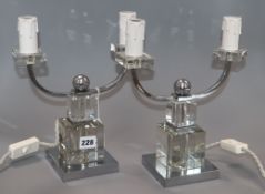 A pair of Art Deco style chromium and glass two-branch candelabra