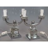 A pair of Art Deco style chromium and glass two-branch candelabra