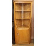 An Ercol Windsor light elm corner cabinet W.76cm