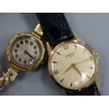 An 18ct gold ladys' wristwatch with silvered cushion-shaped Arabic dial and plated bracelet and an