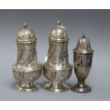 A pair of Victorian silver pepperettes, G.M. Jackson, London, 1882 and a later Edwardian silver