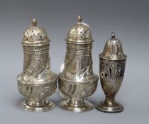 A pair of Victorian silver pepperettes, G.M. Jackson, London, 1882 and a later Edwardian silver