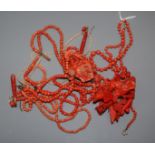 A carved coral floral spray brooch, 78mm, a triple strand coral necklace with carved floral pendant,