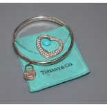 A Tiffany & Co 925 bangle and a 925 heart shaped pendant set with white stones.