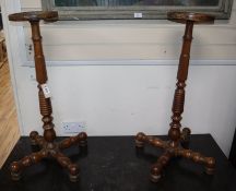 A pair of 19th century continental fruitwood candle stands H.82cm