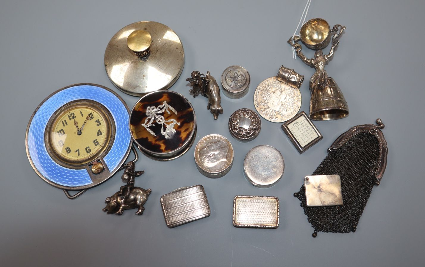 A small collection of silver and white metal items including enamel desk clock, tortoiseshell