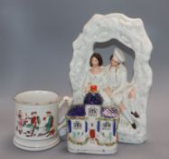 A Staffordshire figure group, a flatback castle and a frog mug