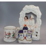 A Staffordshire figure group, a flatback castle and a frog mug